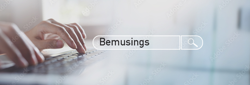 Close-up shot of a keyboard with a person typing "Bemusings" into a search box.